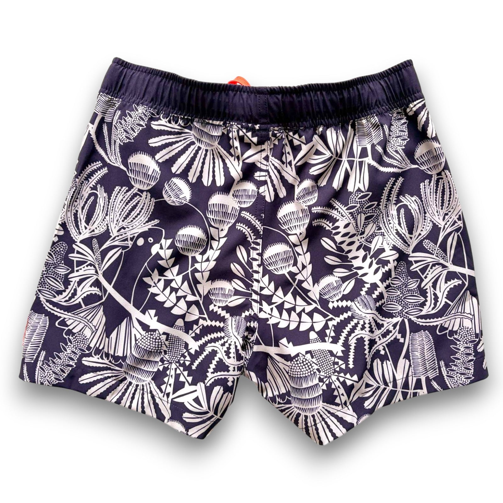 Unisex kids Navy swim shorts with pale sage green Banksia pattern and orange drawstring , made from recycled plastic bottles by South Beach Boardies x Helen Ansell, back view