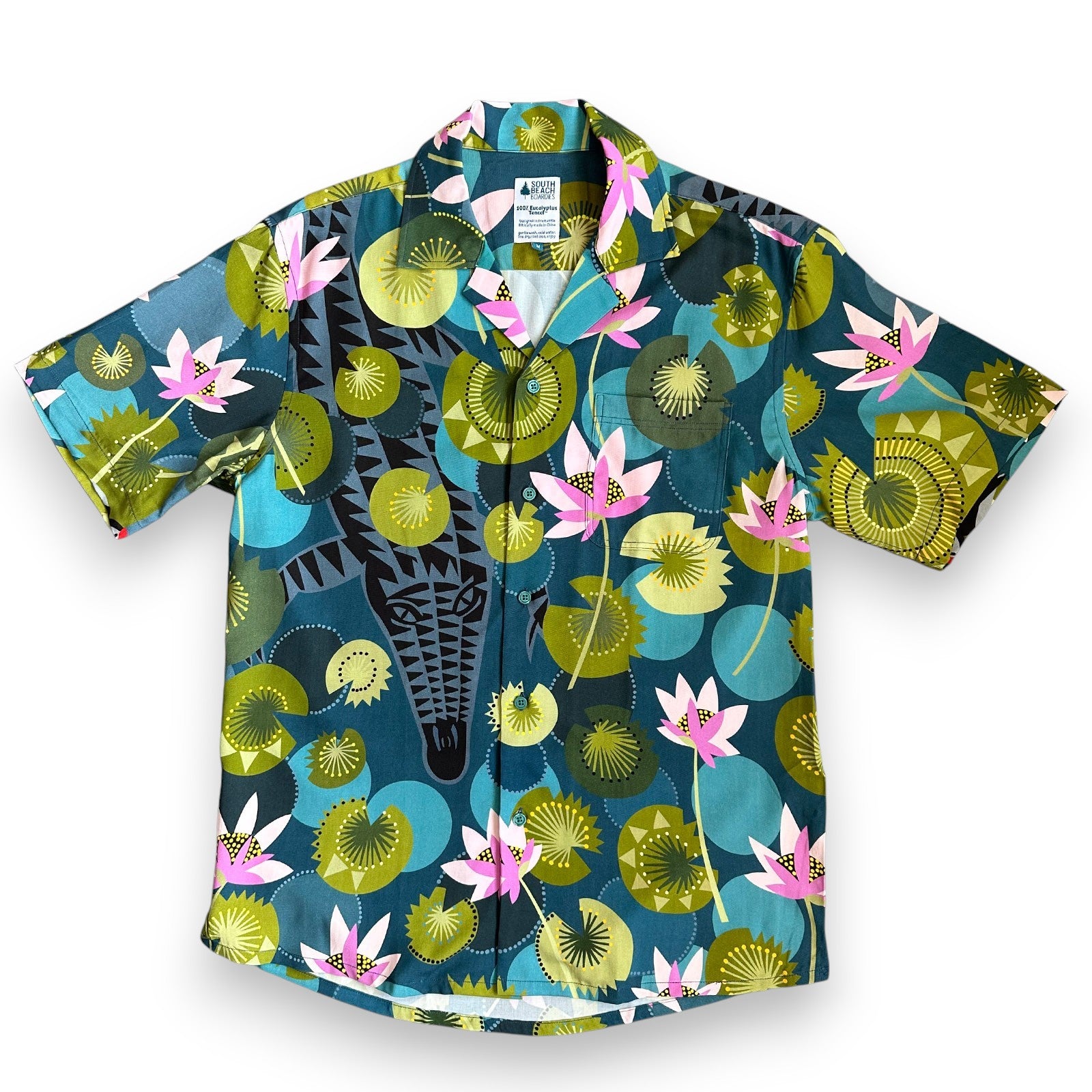 Hidden crocodile swimming in tropical waters with colourful water lilies, a Cubano shirt collaboration by Helen Ansell and South Beach Boardies, front view