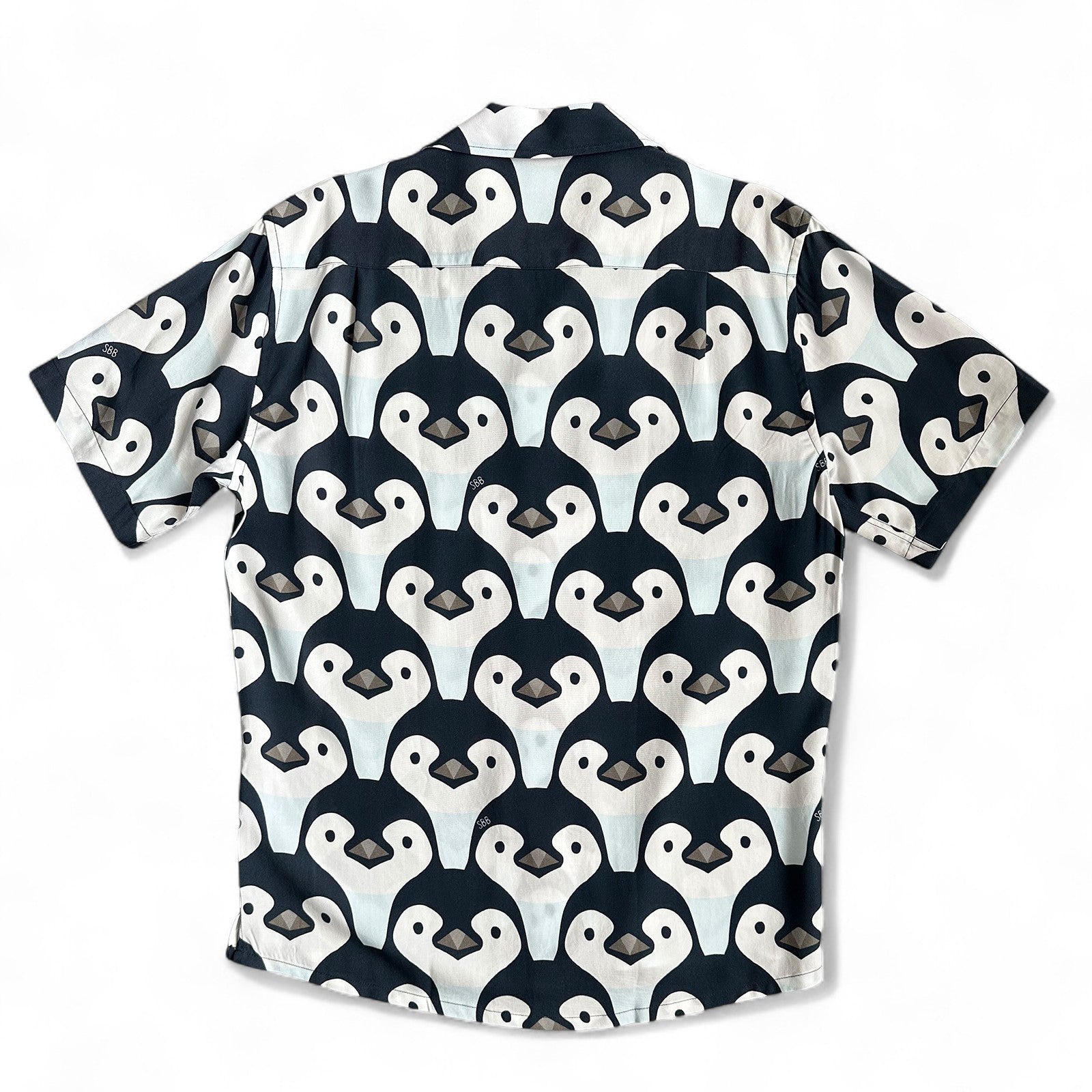 Short-sleeve shirt with penguin pattern on a white background, made by South Boardies
