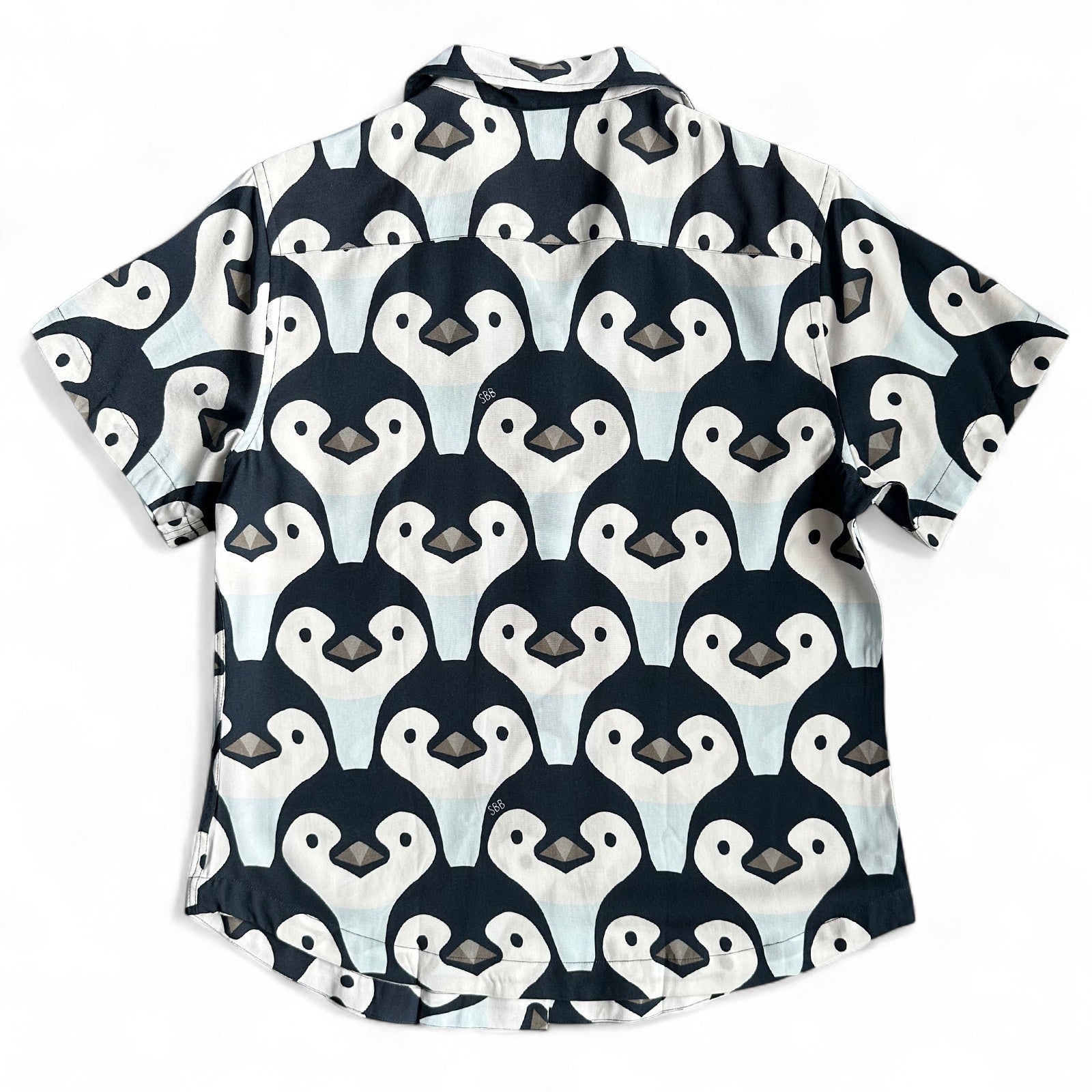 Short-sleeve women's cuban collar shirt with penguin pattern on a white background, made by South Beach Boardies, BACK VIEW