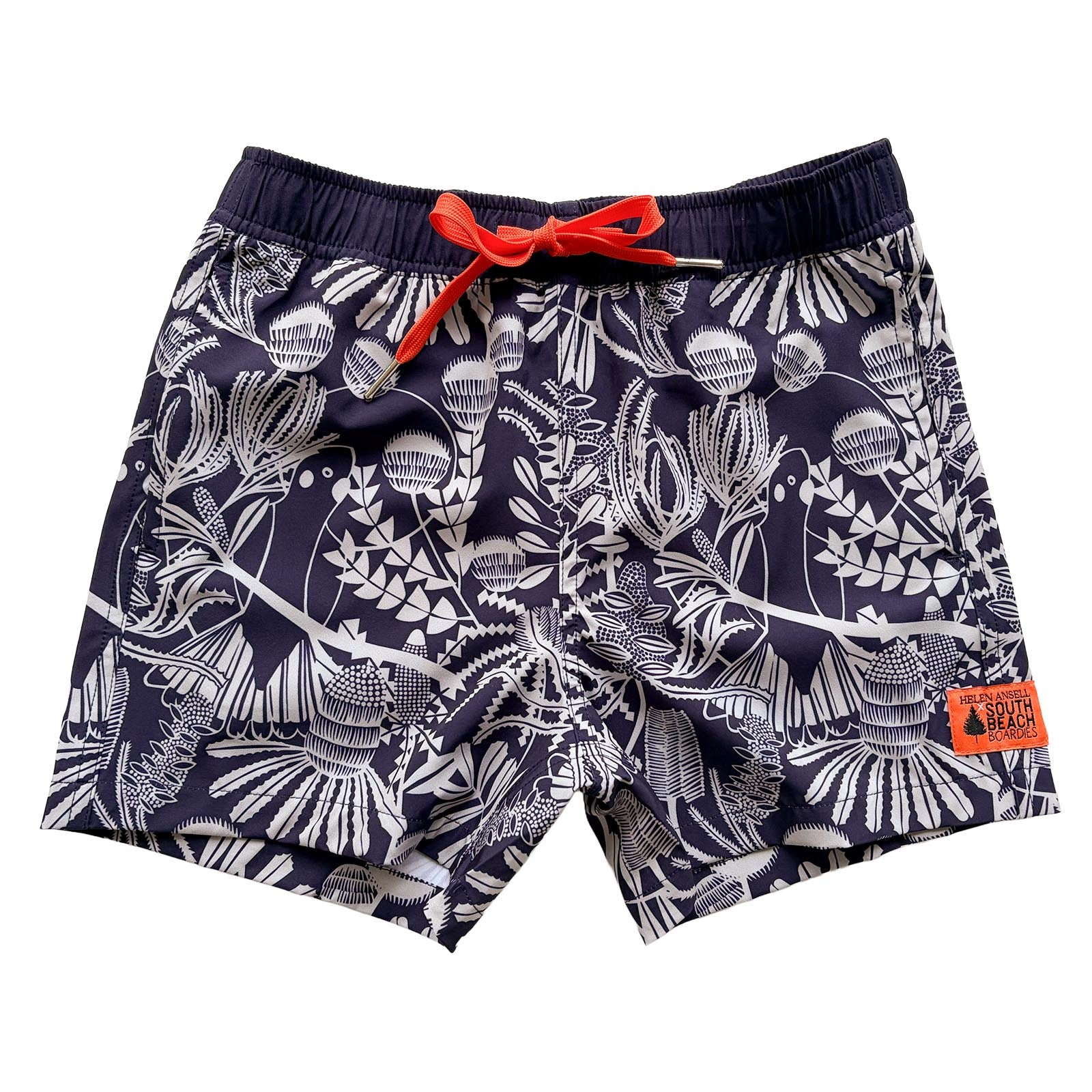 Unisex kids Navy swim shorts with pale sage green Banksia pattern and orange drawstring , made from recycled plastic bottles by South Beach Boardies x Helen Ansell, frontview