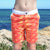 Boy wearing SBB Kids Going Out Boardies recycled Orange Crush front view