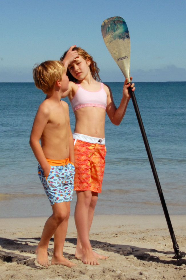 Kids wearing SBB Kids Going Out Boardies, boy in Hooray for Fish!, girl in Orange Swirl
