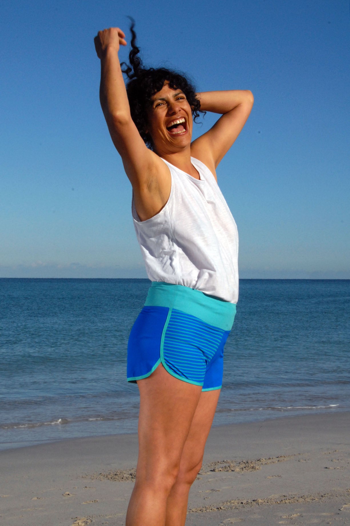 Woman wearing SBB Womens Cute Butt Boardies from recycled plastic in Sea Stripe, side view