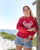 Tegan wears 100% Recycled Fair Trade Ocean Pollution Makes Me Crabby Red Sweatshirt, by South Beach Boardies