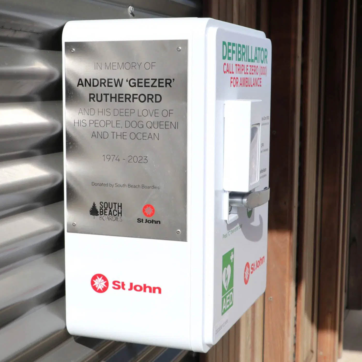 Defibrillator in memory of Andrew 'Geezer' Rutherford with South Beach and St. John branding.