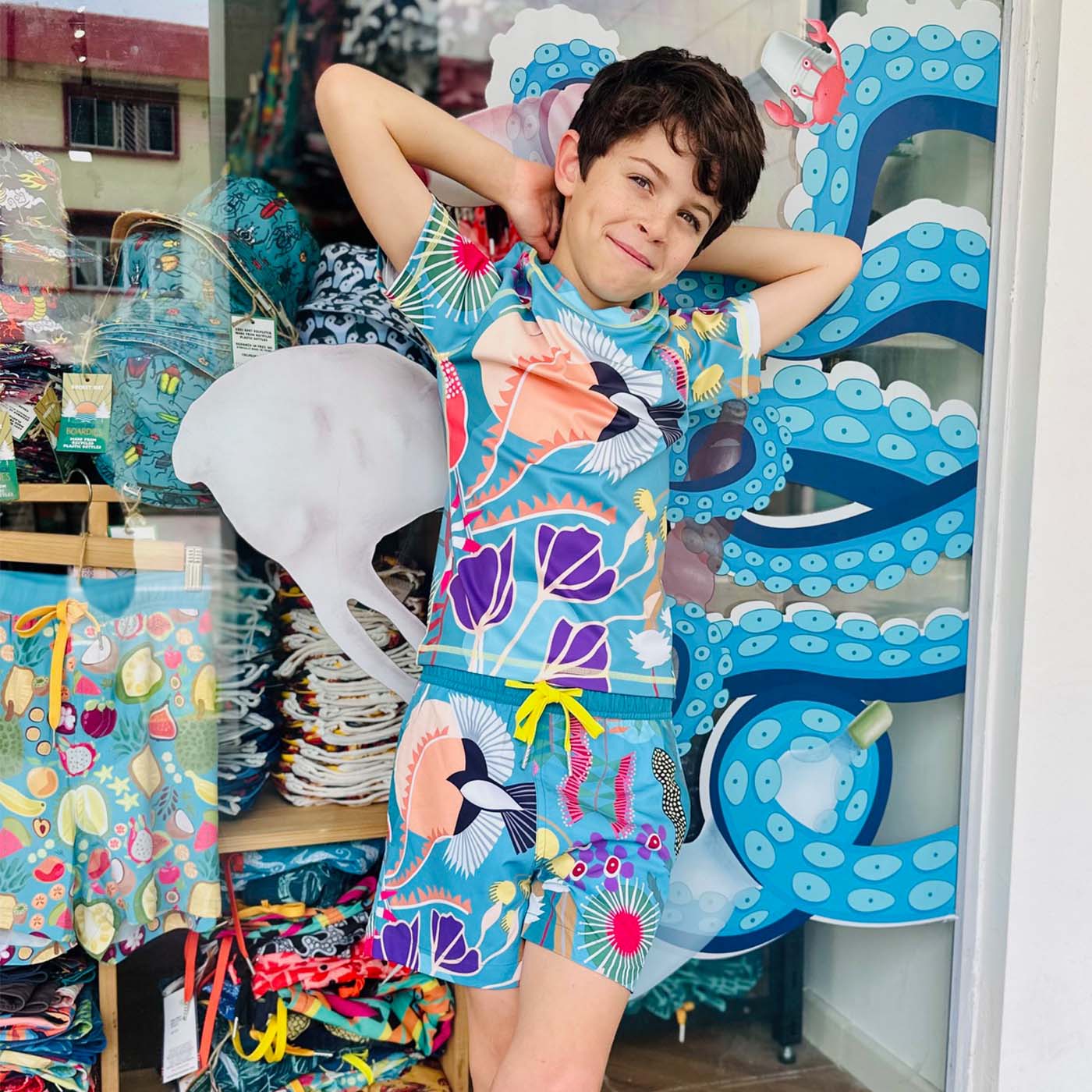 Child wearing a colorful swimsuit standing in front of South Beach Boardies Joo Chiat Store 2 Fowlie Rd 01-05 Singapore 428505