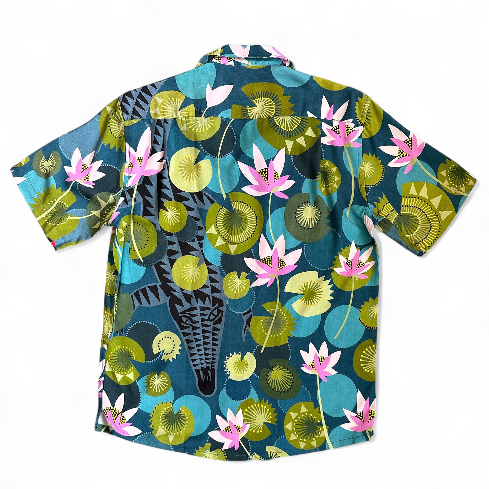 Hidden crocodile swimming in tropical waters with colourful water lilies, a Cubano shirt collaboration by Helen Ansell and South Beach Boardies, front view