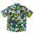 Hidden crocodile swimming in tropical waters with colourful water lilies, a Cubano shirt collaboration by Helen Ansell and South Beach Boardies, front view