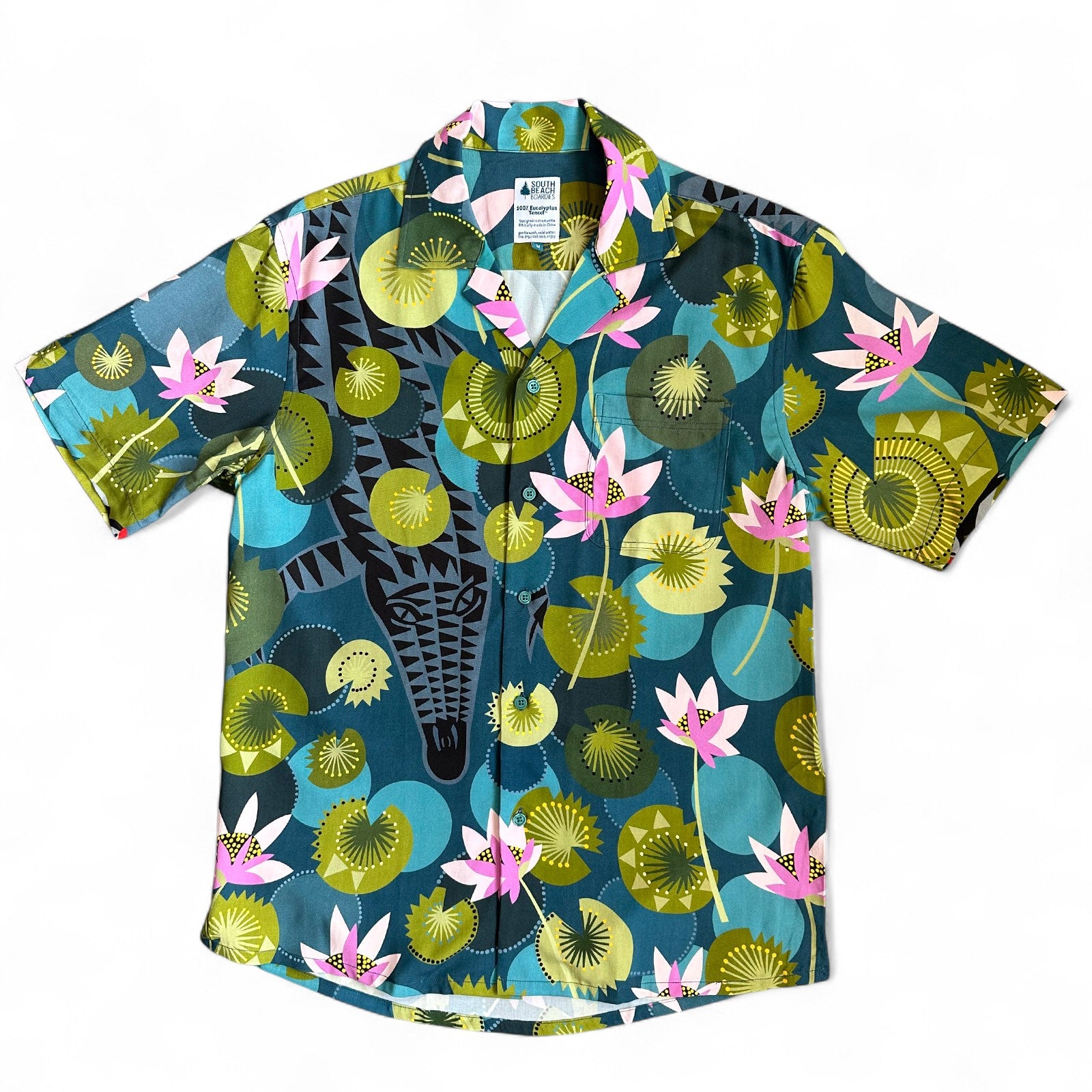 Hidden crocodile swimming in tropical waters with colourful water lilies, a Cubano shirt collaboration by Helen Ansell and South Beach Boardies, front view