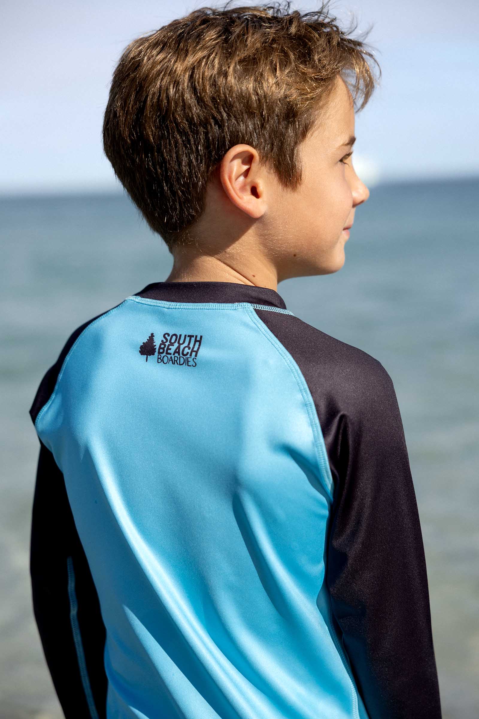 South Beach Boardies long sleeve rashie UPF50 made from recycled plastic bottles, blue body fabric with black sides