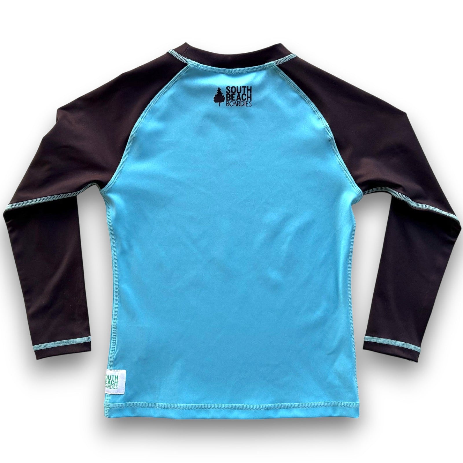South Beach Boardies Kids Long-Sleeved UPF50 Recycled Rashie made from recycled plastic bottles, featuring sblack South Beach Boardies tree logo on blue background with long black sleeves, fback view
