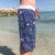 Boy wearing South Beach Boardies Kids Long Boardies recycled plastic Sea Dragons right side view