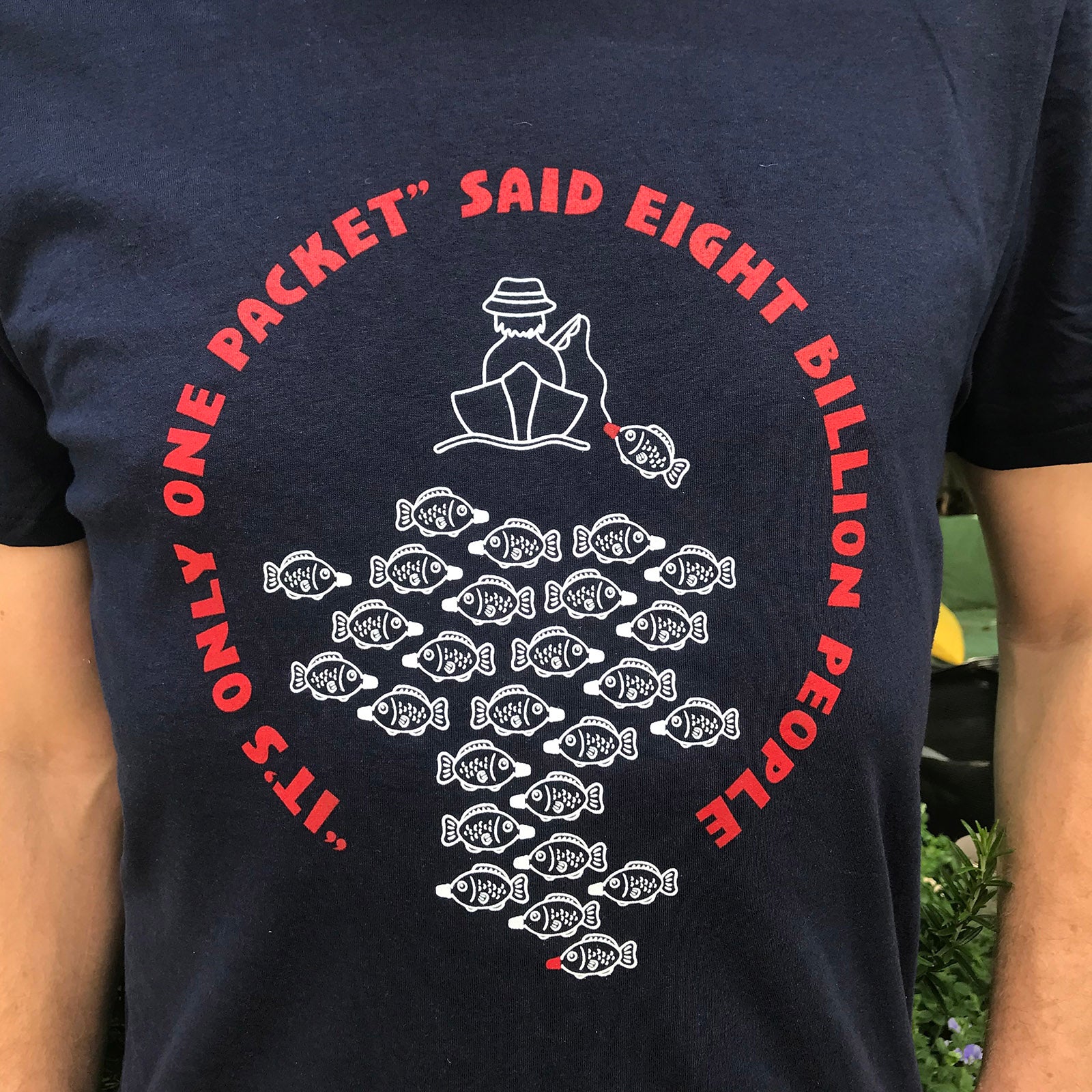 Man wearing It's Only One Packet Soya Sauce Plastic Fish T-shirt