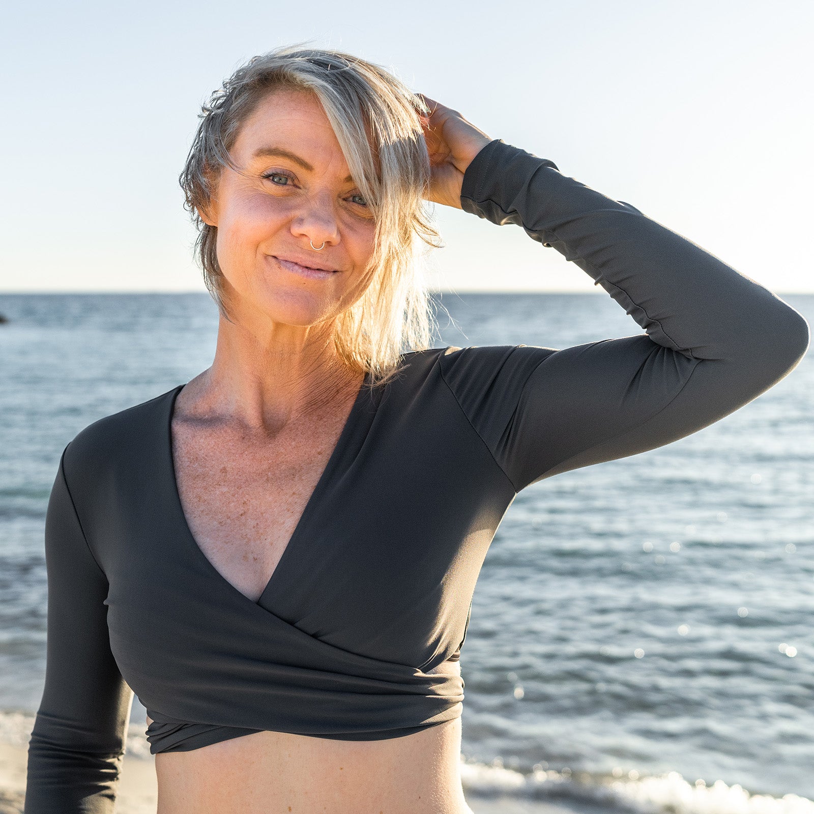 South Beach Boardies Women's Titanium Rashie Shrug made from recycled fishing nets, worn by Leela at South Beach Dog Beach