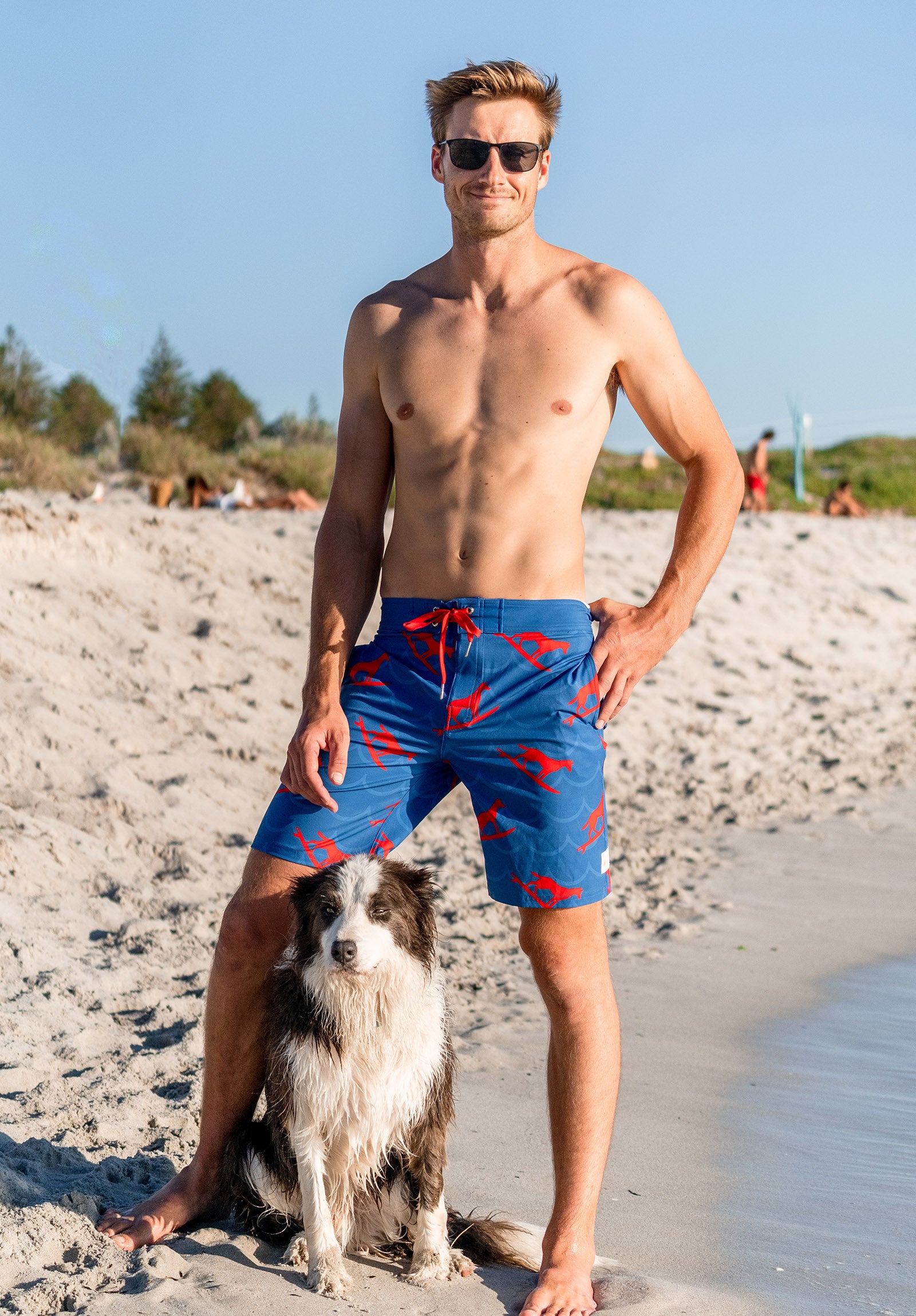 South Beach Boardies recycled sustainable mens surfer Boardies in Dingo Took My Board(ies) print, man and dog at South Beach Dog Beach
