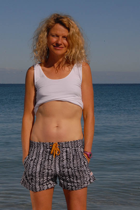 Freo Mum of two Kate, wearing South Beach Boardies Womens Summer Shorts in Tribal, made from recycled plastic bottles